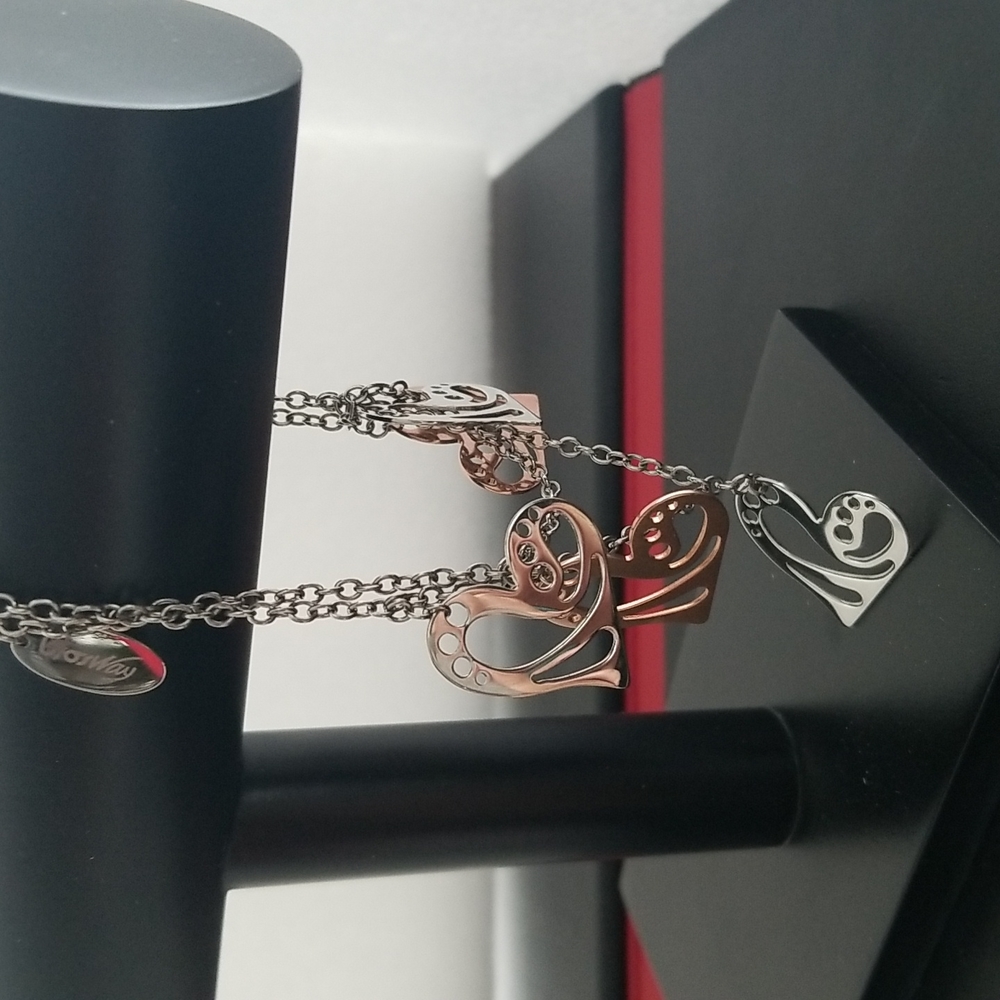 Women double chained bracelet silver and copper heart shaped charms.